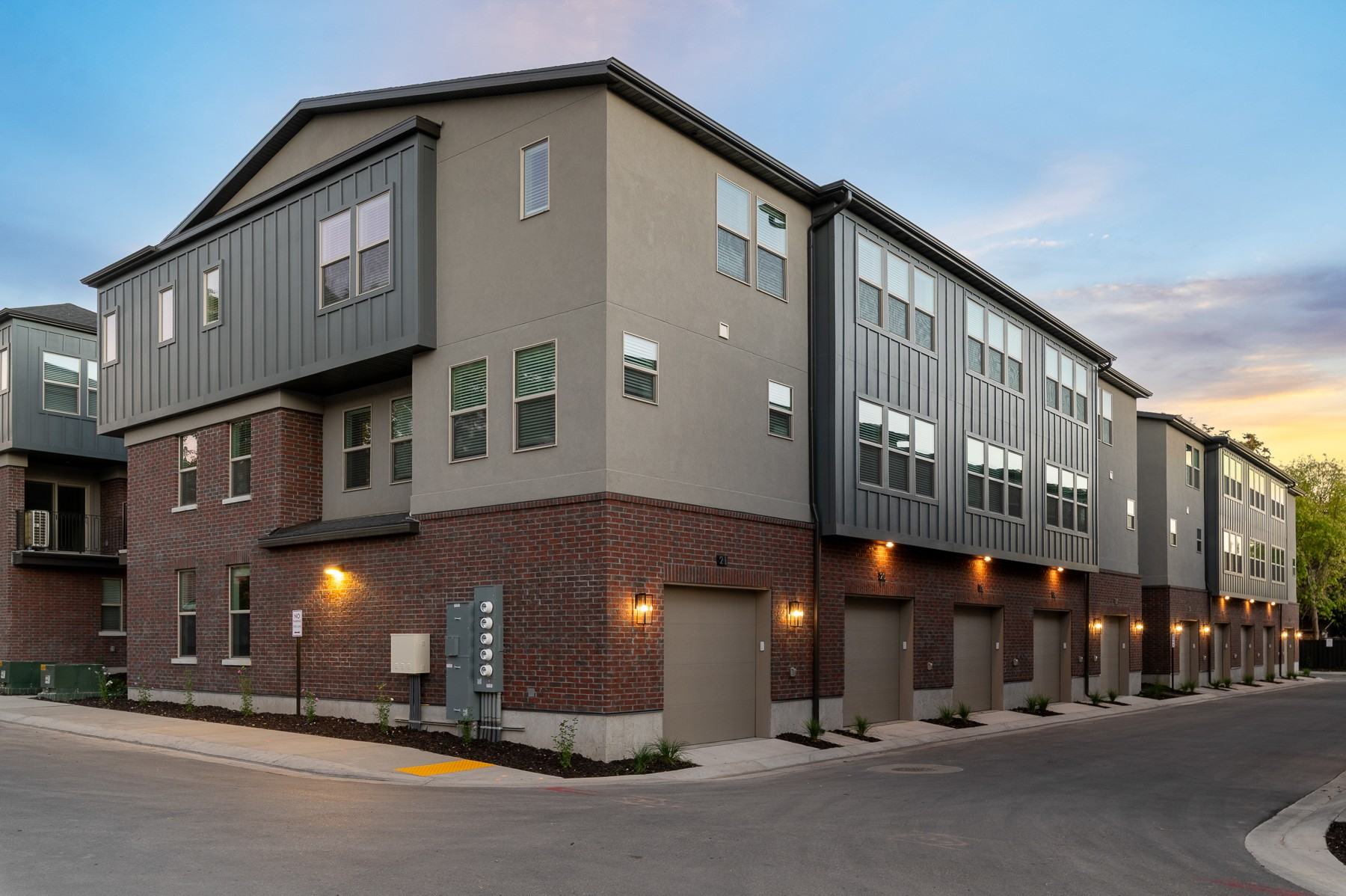 Liberty Wells townhomes and garages at dusk