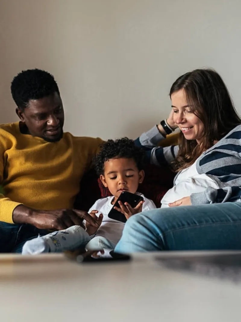 A family looking at a phone together